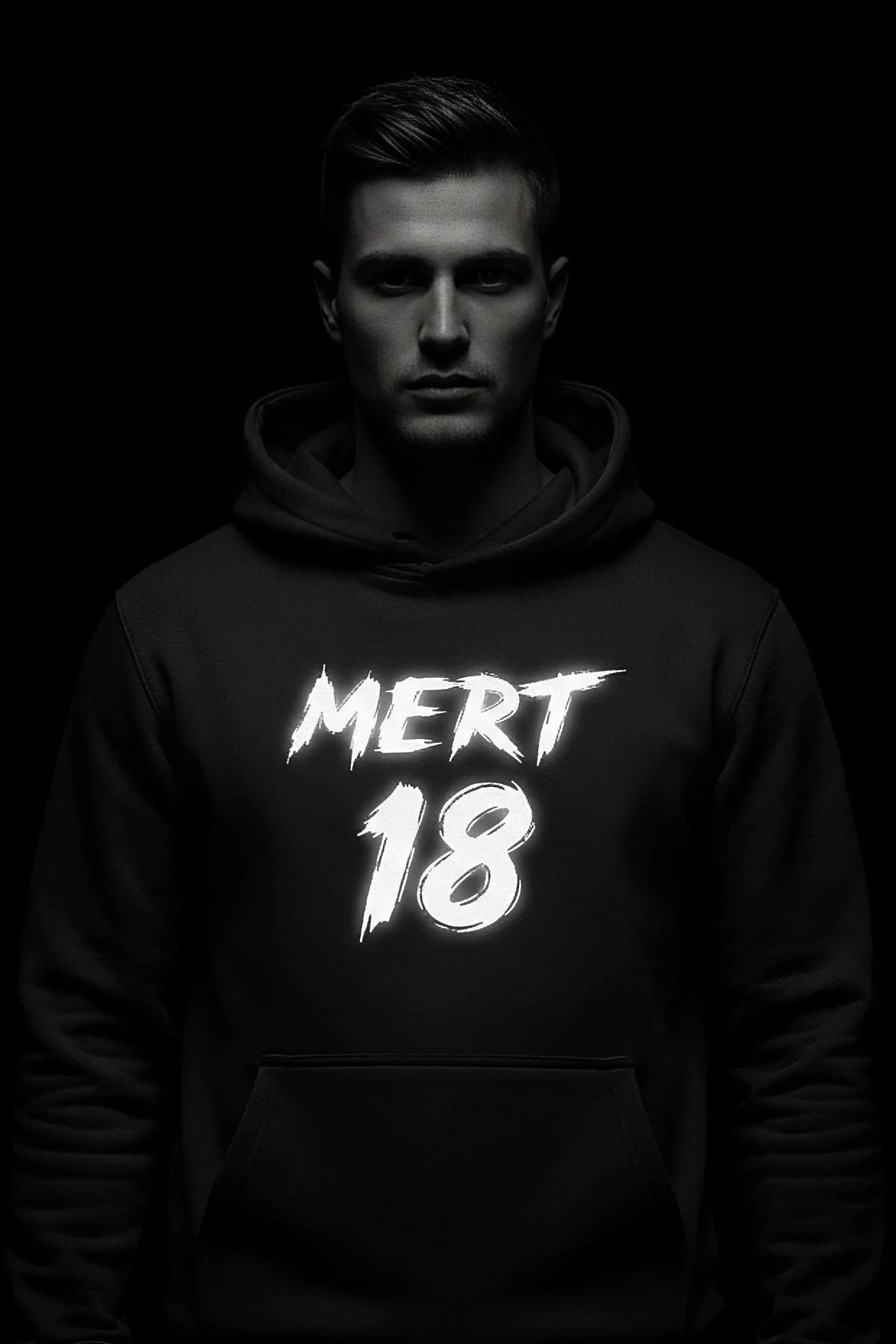 Black custom reflective graphic hoodie on a man, white brushed text "MERT 18"