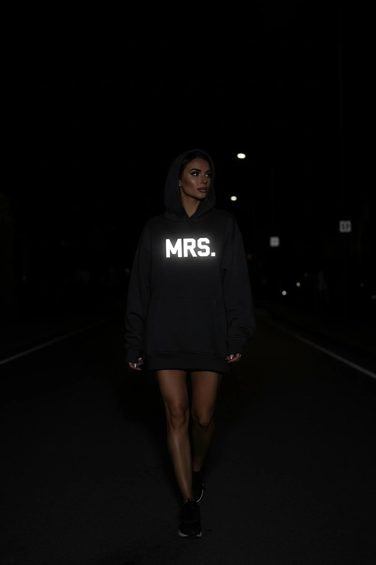 Reflective Mrs. hoodie in black with glow-in-the-dark front print worn at night