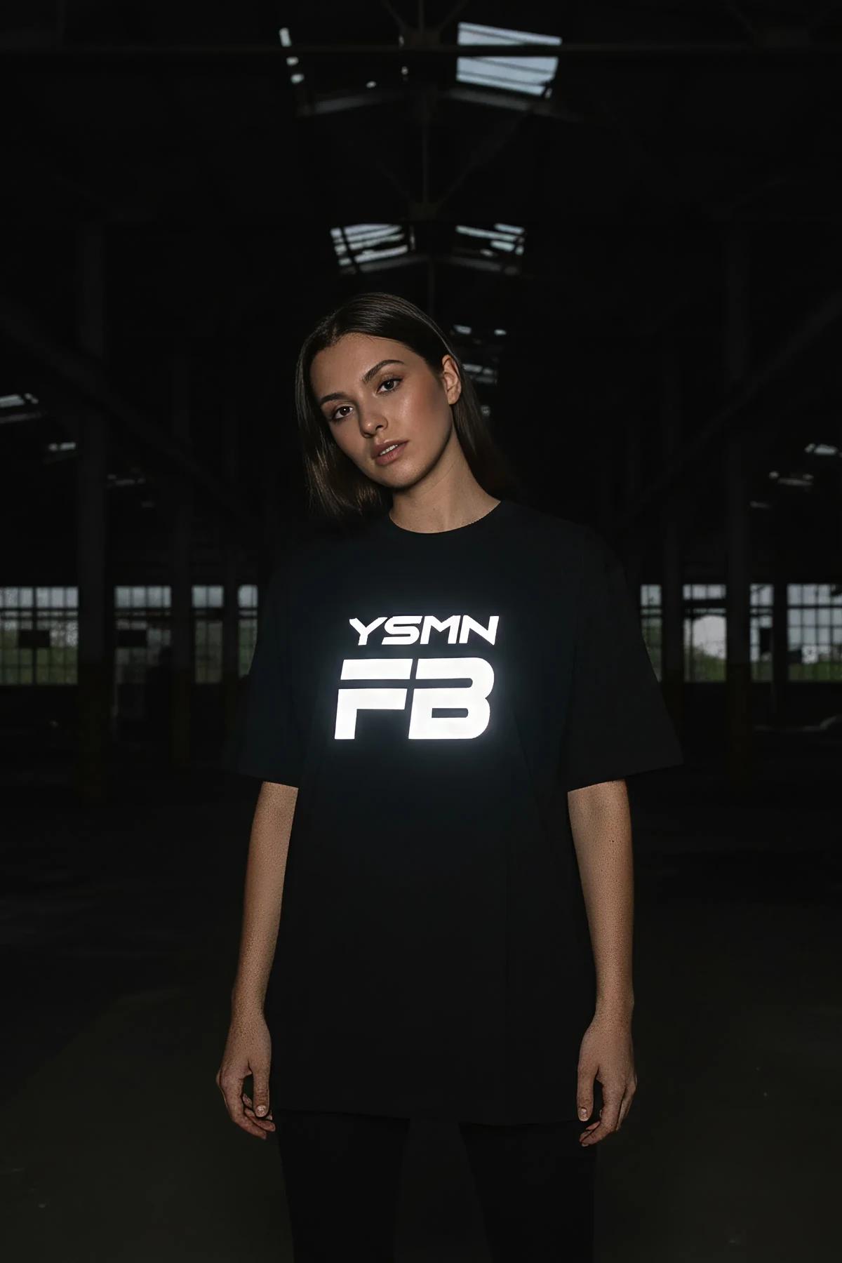 Side profile of model wearing the black reflective graphic tee