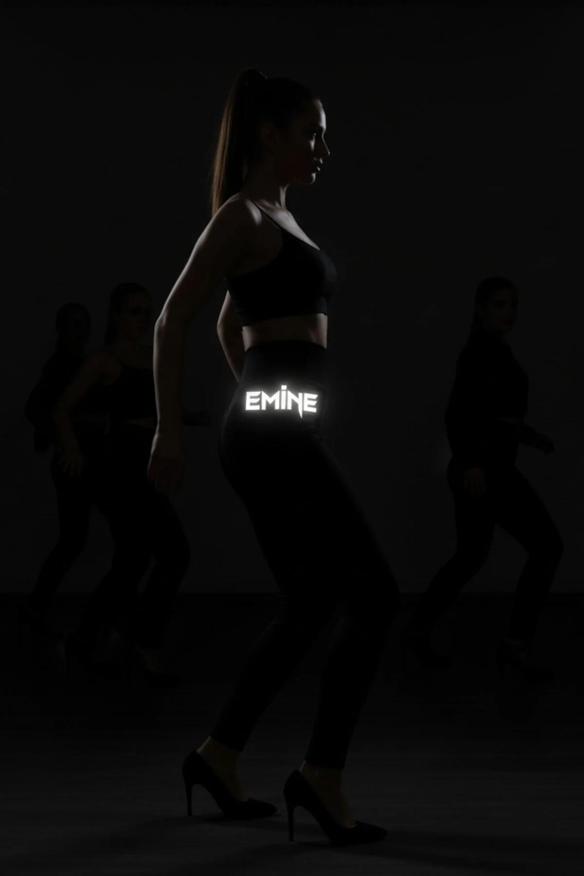 Flat Lay of Black Reflective Leggings with Glowing FT M Logo Detail