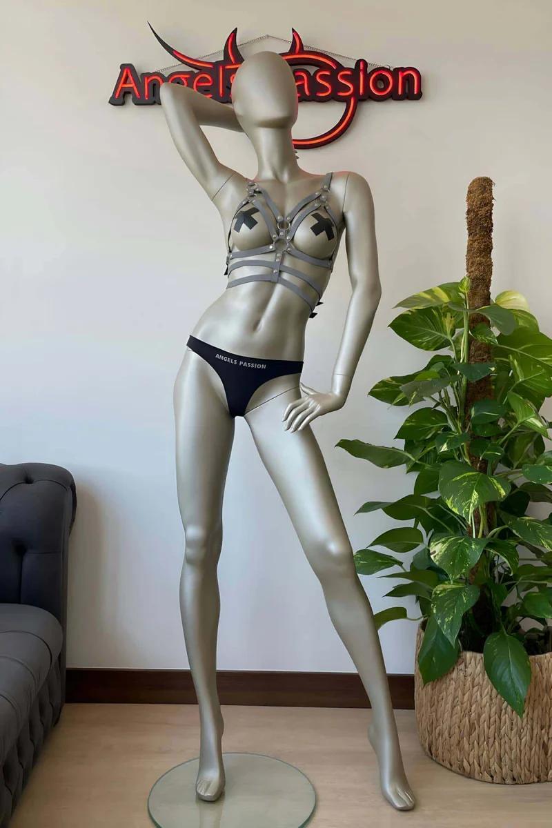 Reflective silver chest harness with matching choker set on mannequin in festival outfit display