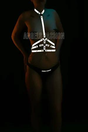 Reflective body harness with silver chain accents on model