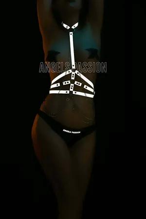 Reflective body harness with silver chain accents on model