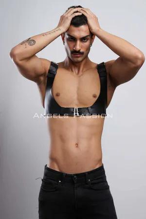 Black faux leather chest harness with silver buckle and adjustable straps on male model