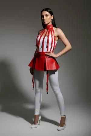 Red faux leather integrated harness top with flared mini skirt, model wearing black heels and white leggings.