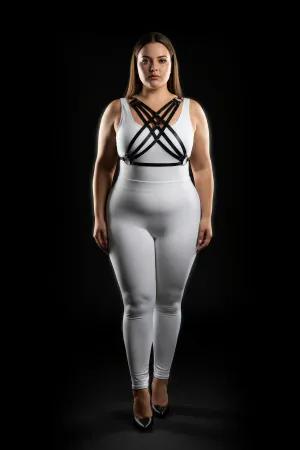 Black faux leather strappy chest harness worn by a plus-size model
