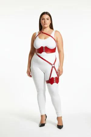 Red vegan leather strappy body harness with O-ring leg detail worn by a model