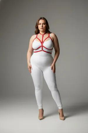 Red vegan leather body harness with adjustable straps and a central O-ring worn by a plus-size model