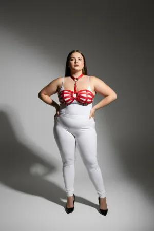 Red faux leather strappy chest harness with O-ring detail worn by a plus-size model