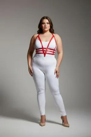 Red faux leather body harness with adjustable straps worn by a plus size model