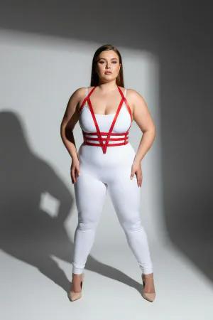 Red faux leather body harness with adjustable straps worn by a plus size model