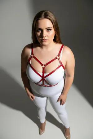 Red faux leather strappy body harness on a plus-size model