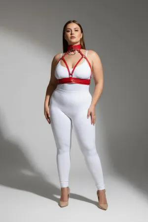 Red faux leather strappy body harness with matching choker and O-ring, worn by a plus-size model.