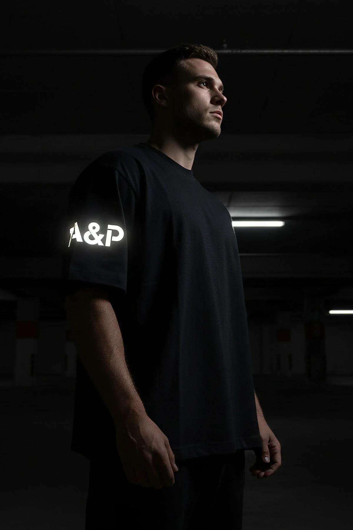 oversized black t-shirt side view elongated hem mid-thigh length streetwear styling