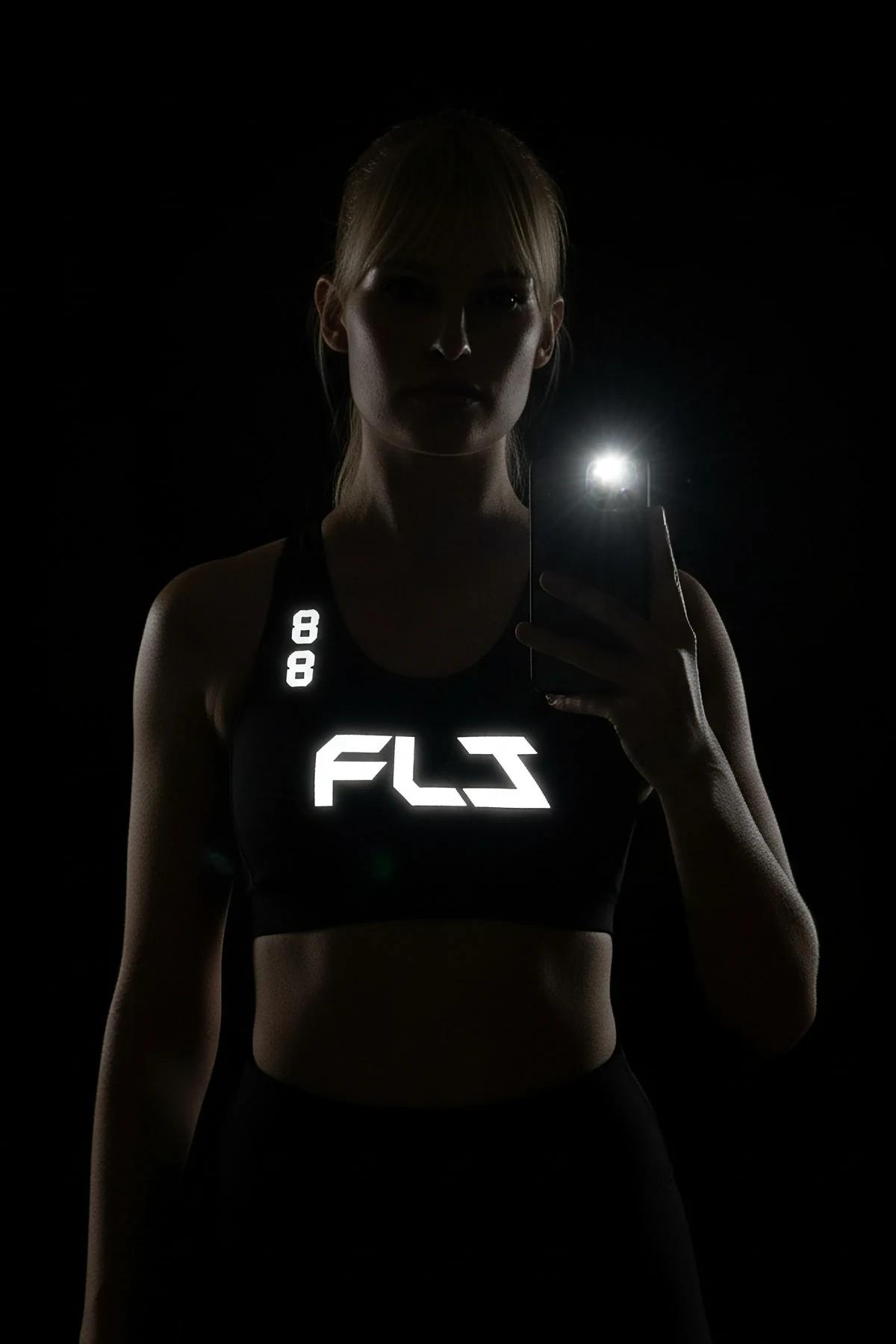 black personalized sport jersey showing reflective block-font name text below oversized number