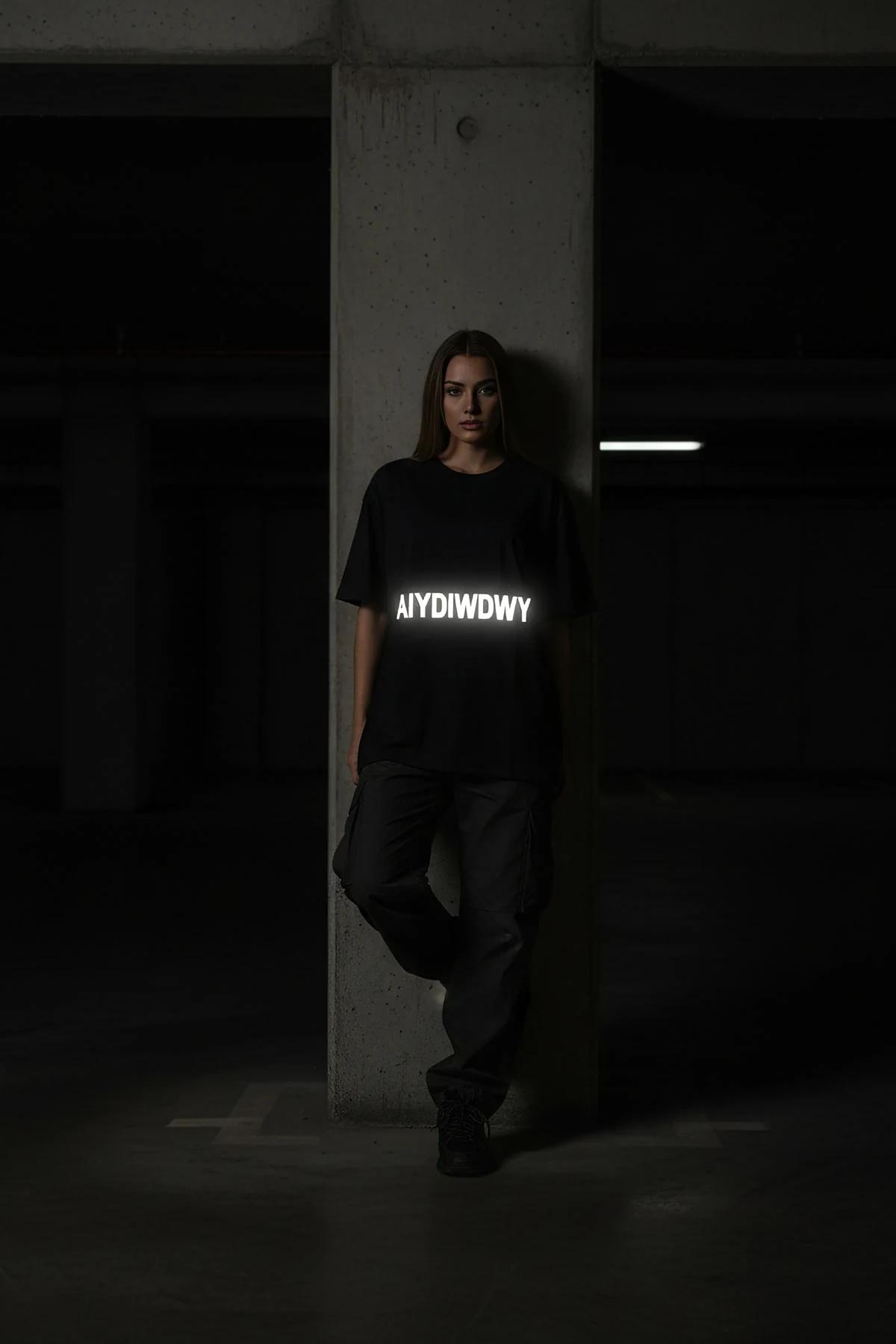 black oversized t-shirt drop-shoulder silhouette full-length view, styled with cargo pants and boots