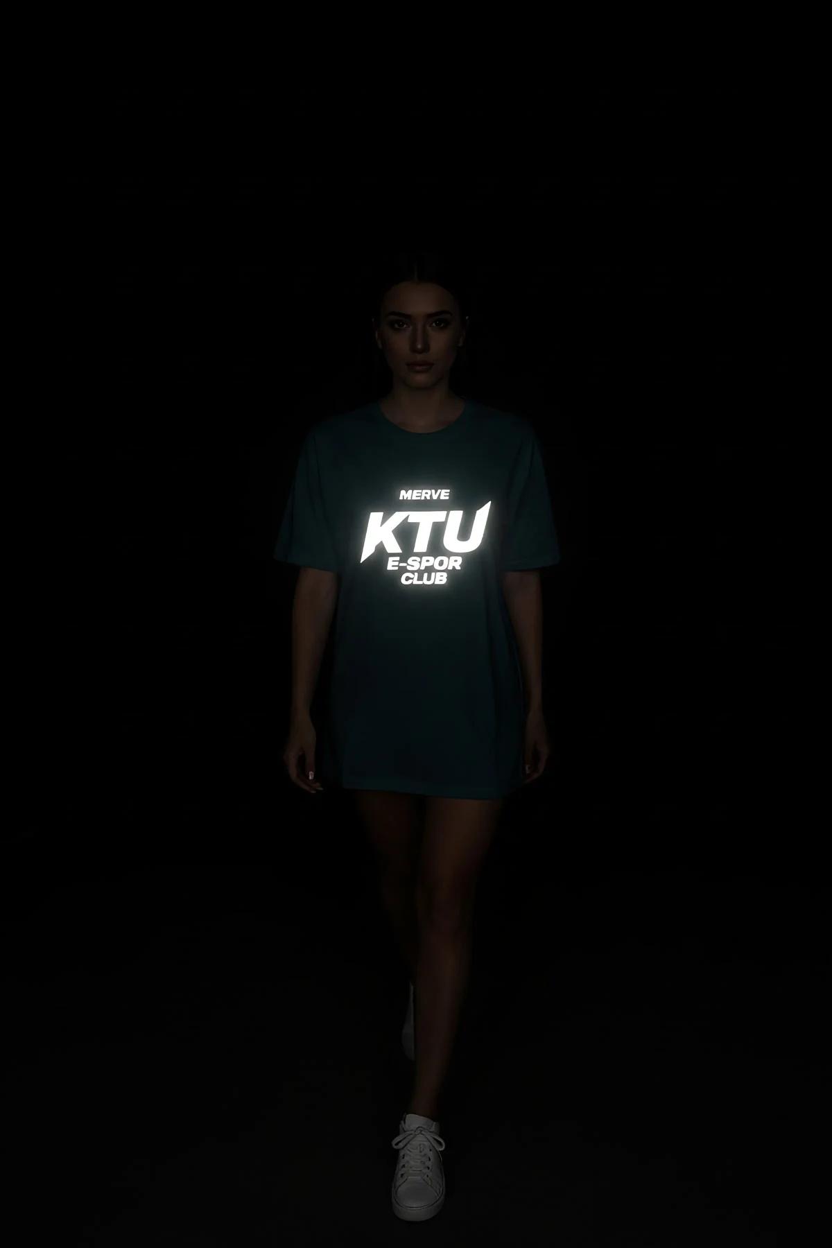 black reflective graphic t-shirt full body shot with glowing chest logo under dark conditions