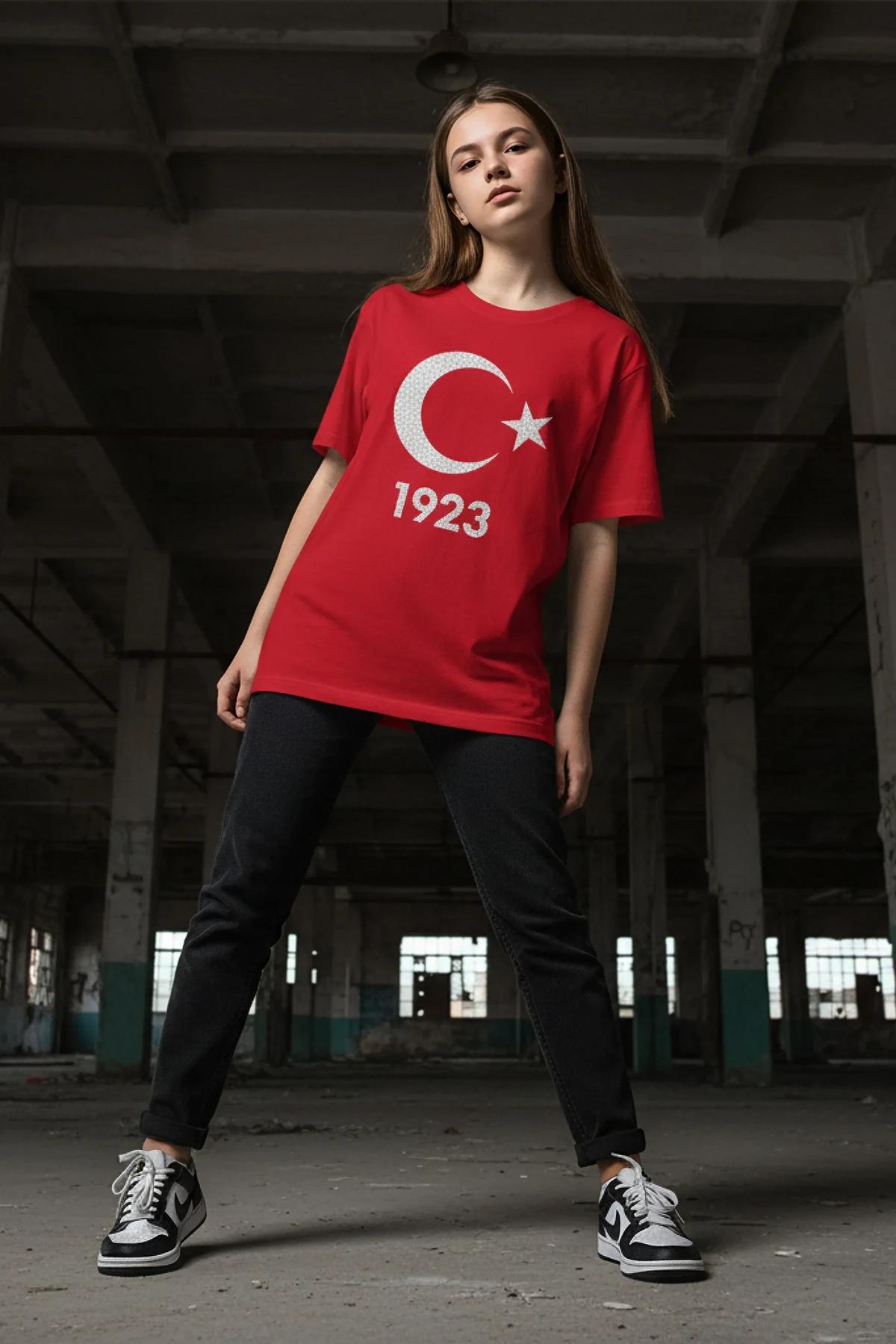 oversized red graphic tee with 1923 crystal numeral detail worn tucked into black jeans