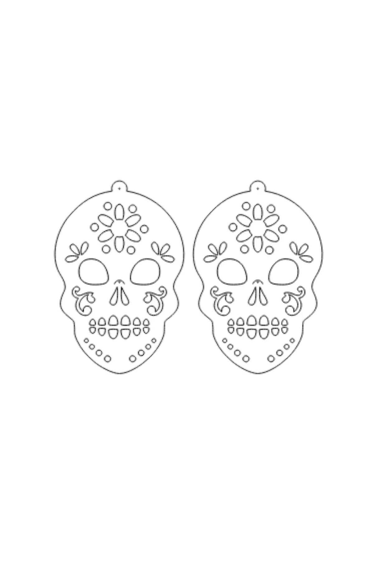 Close-up of open floral and eye cutwork pattern on matte black skull pendant