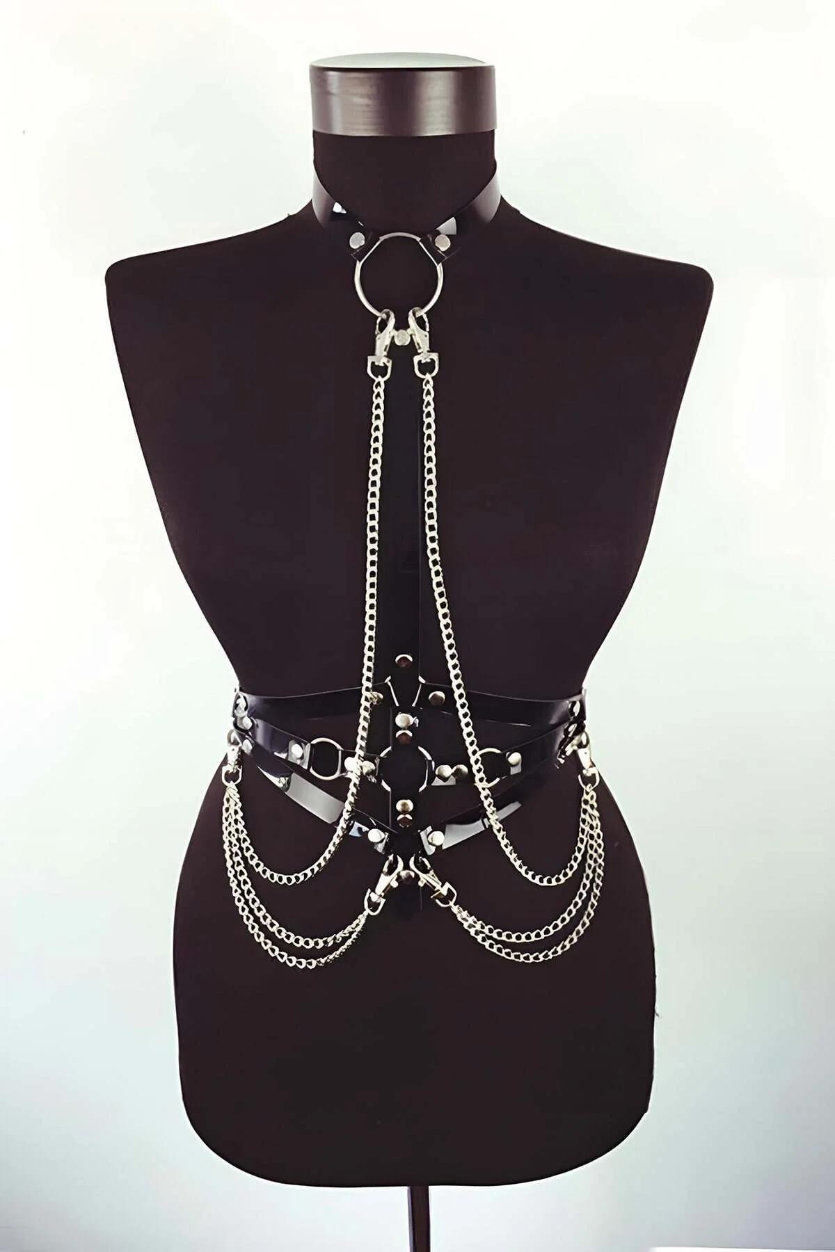 Black faux leather body harness with silver O-ring collar and three draped chain tiers on mannequin