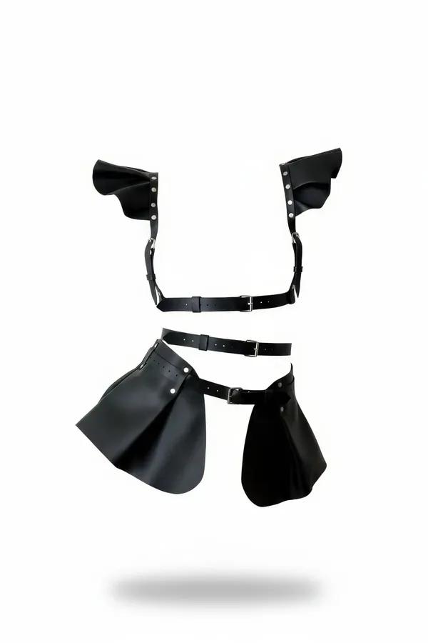 black faux leather shoulder harness with structured wing panels and detachable two-panel wrap skirt, silver-tone buckles
