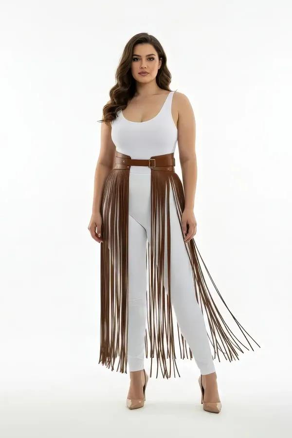 Brown faux leather waist harness skirt with long cascading fringe tassels over white leggings, gold buckle detail