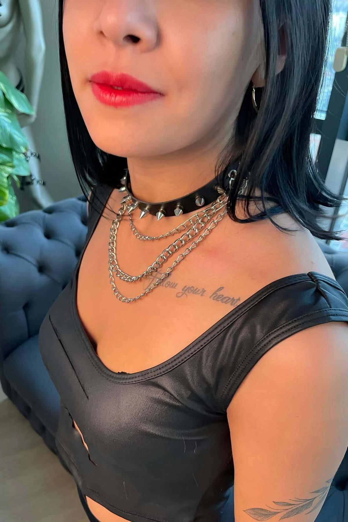 Two silver-tone chain necklaces at 38 cm and 44 cm layered below the spiked choker