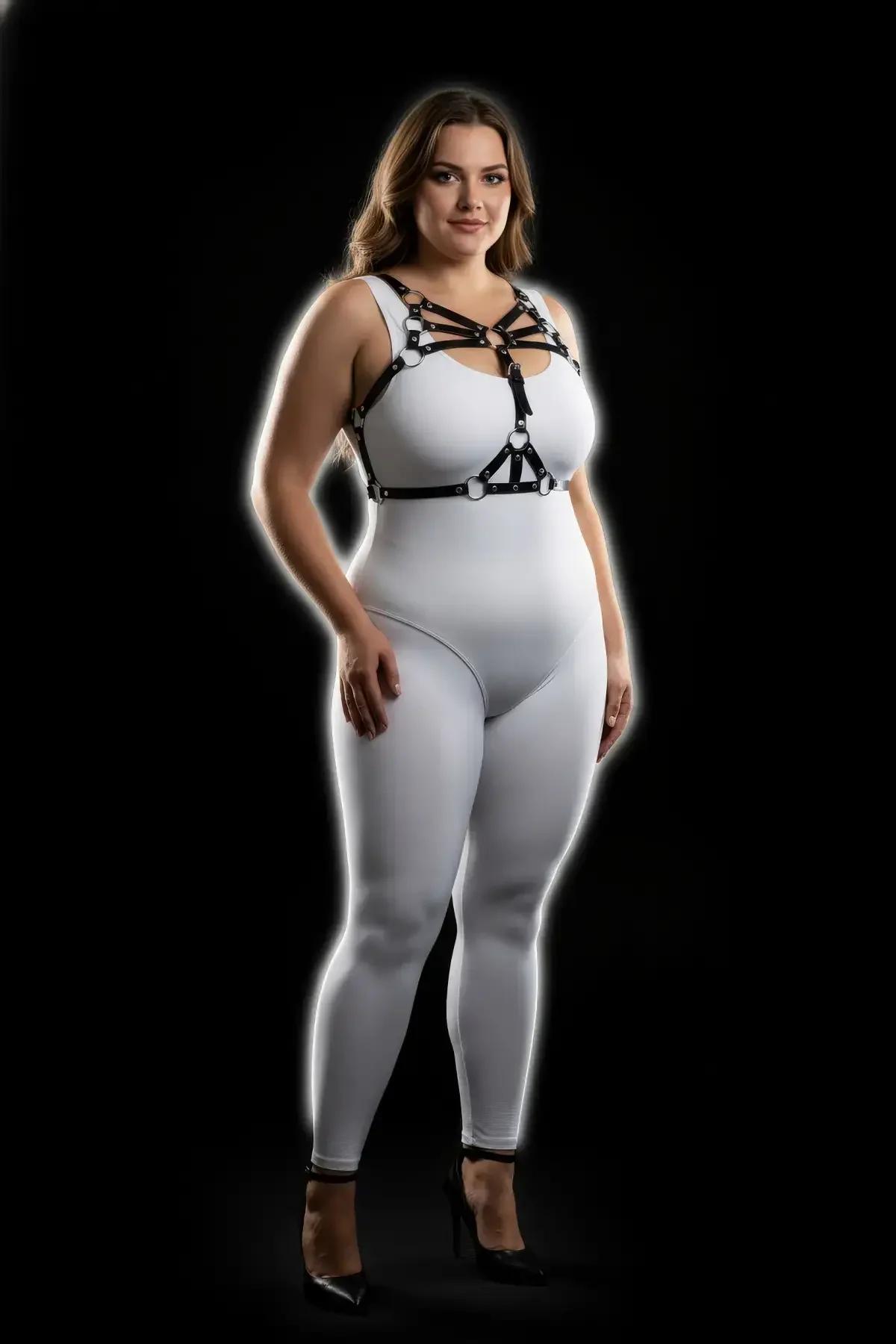 Matte black strappy chest harness silver O-ring connectors at sternum close-up