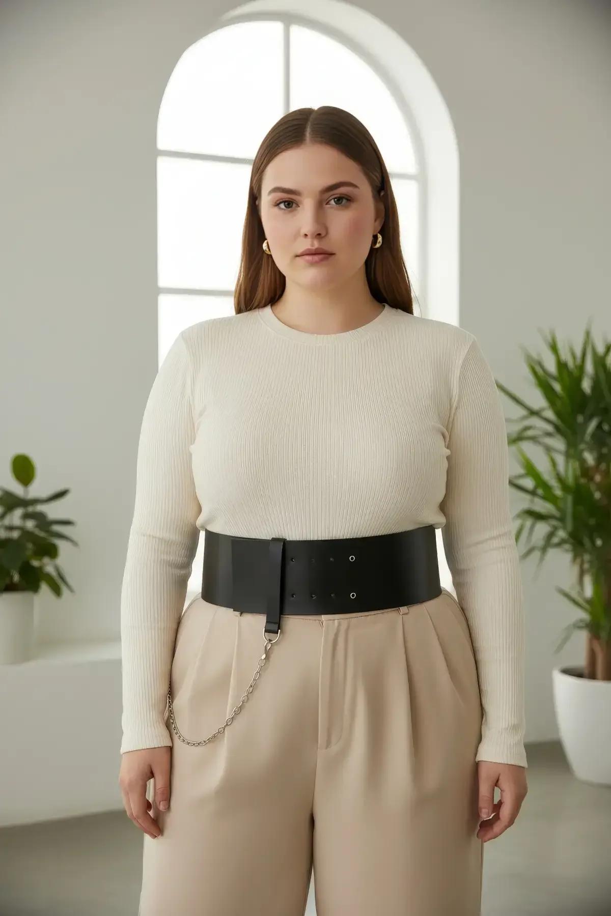 Close-up of double silver-tone eyelet rows on black matte faux leather wide waist belt