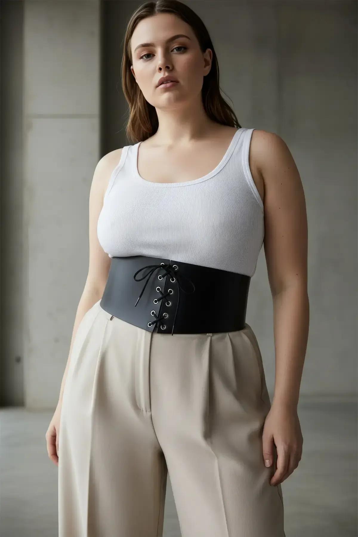 back view of black faux leather wide waist cincher showing smooth PU surface and fit