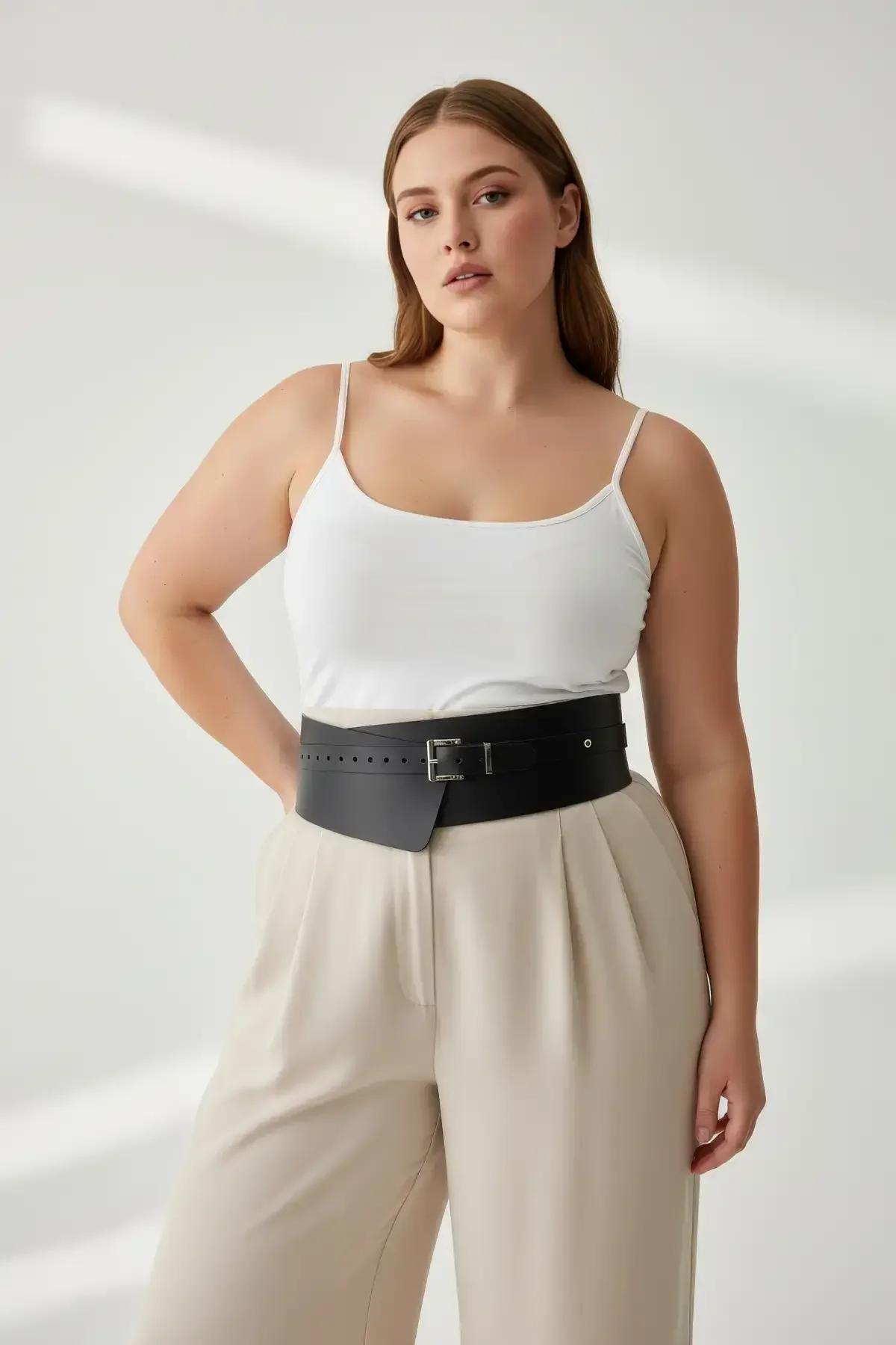 Close-up of silver-tone rectangular buckle on black wide structured waist belt