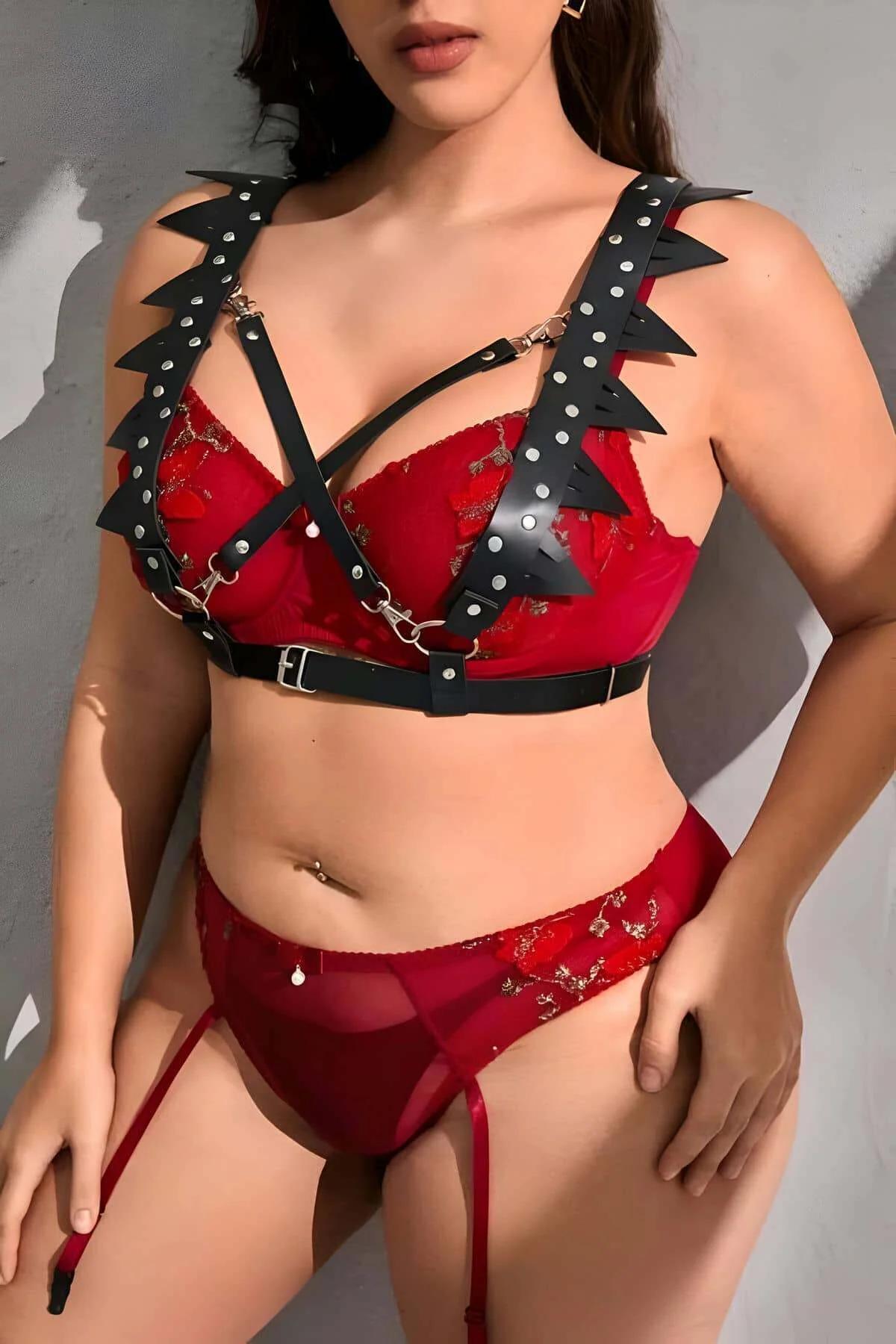 Black spiked chest harness with gold O-ring connectors and adjustable under-bust buckle detail
