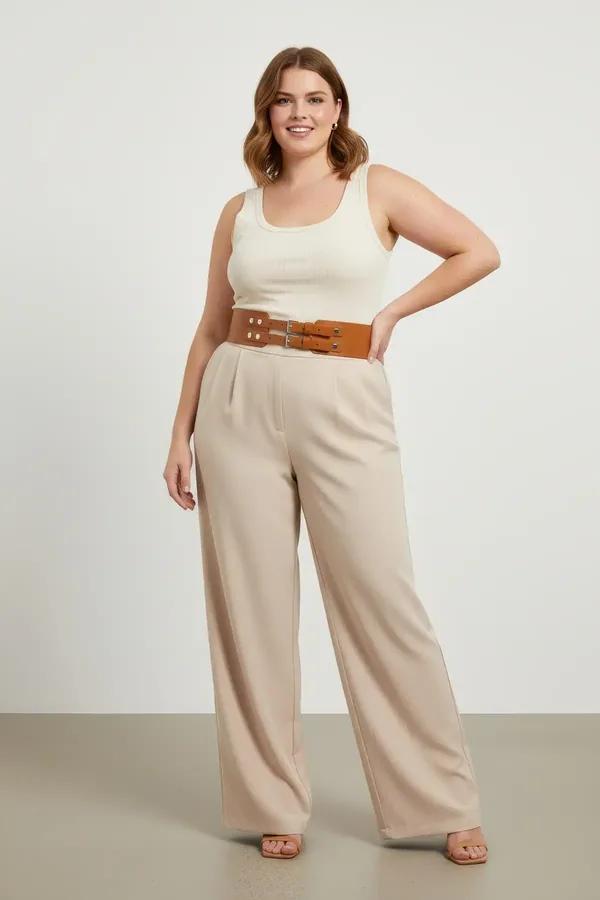 wide tan faux leather corset belt with double silver buckles worn over white tank and linen trousers
