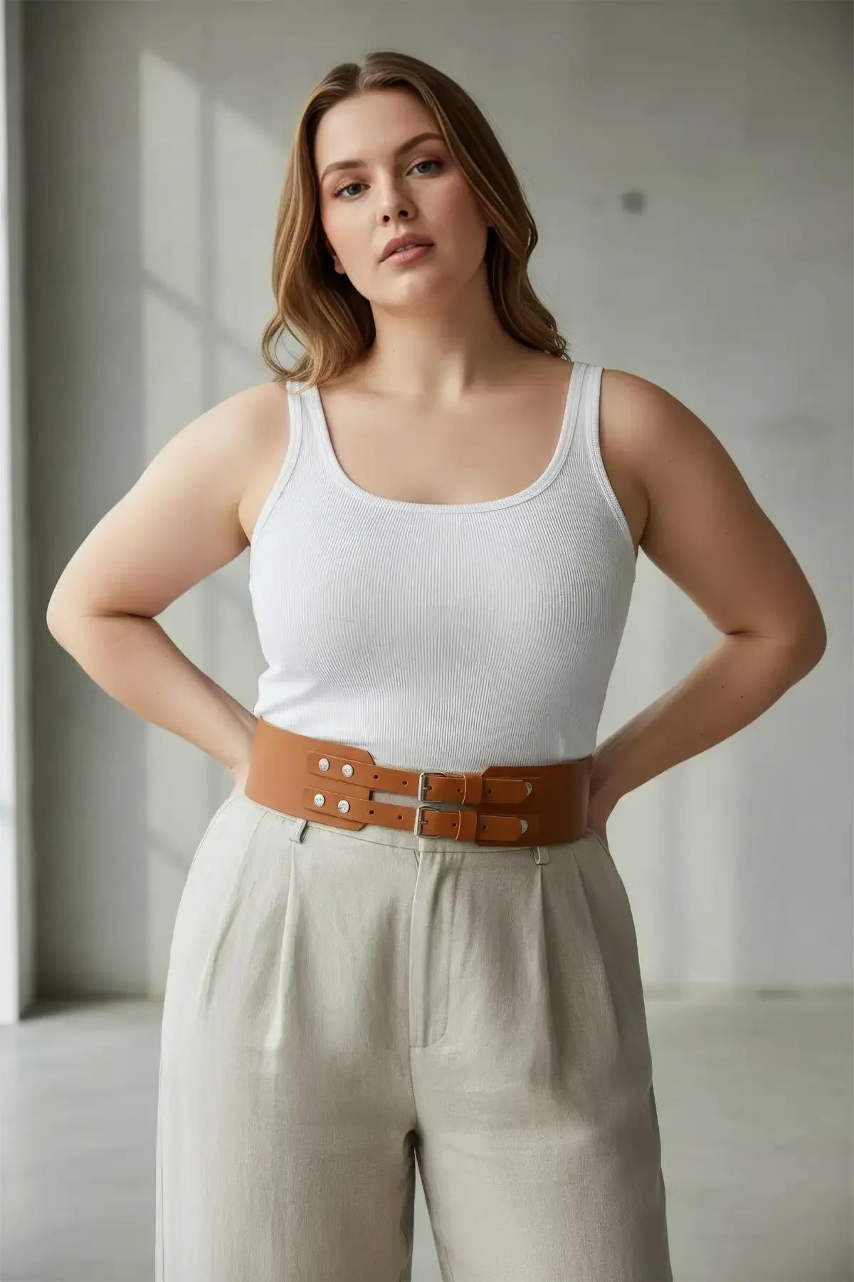 wide faux leather waist belt in cognac tan cinched over cream outfit full length view