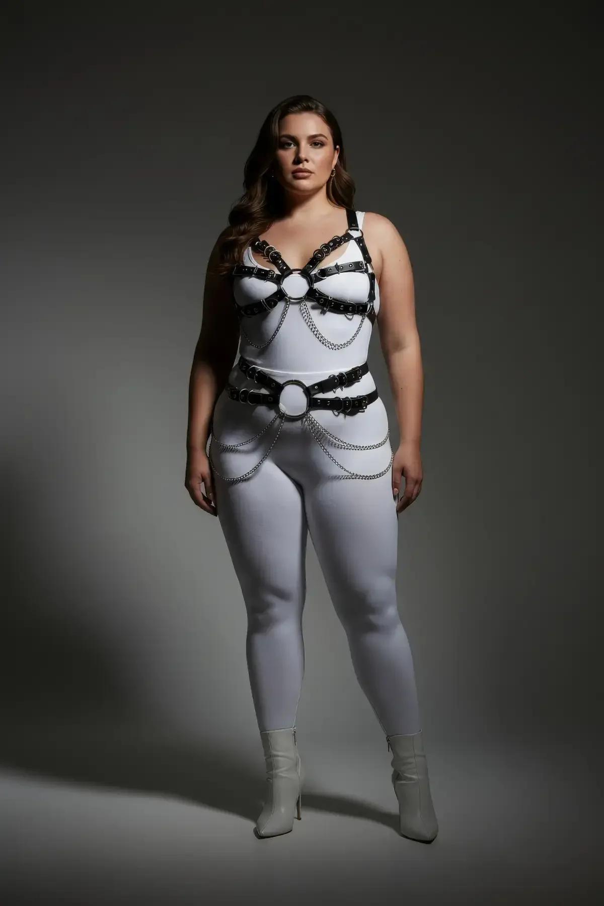 Close-up of silver-tone link chain and buckle hardware on black faux leather body harness
