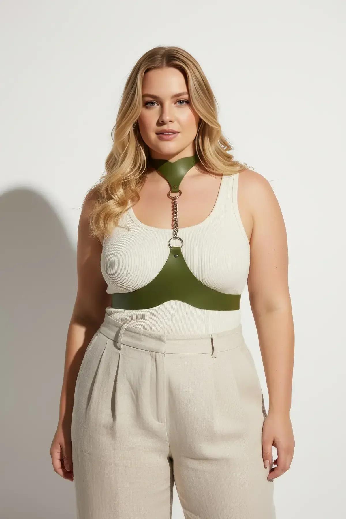 Olive green minimalist chest harness styled over white top with beige trousers casual outfit