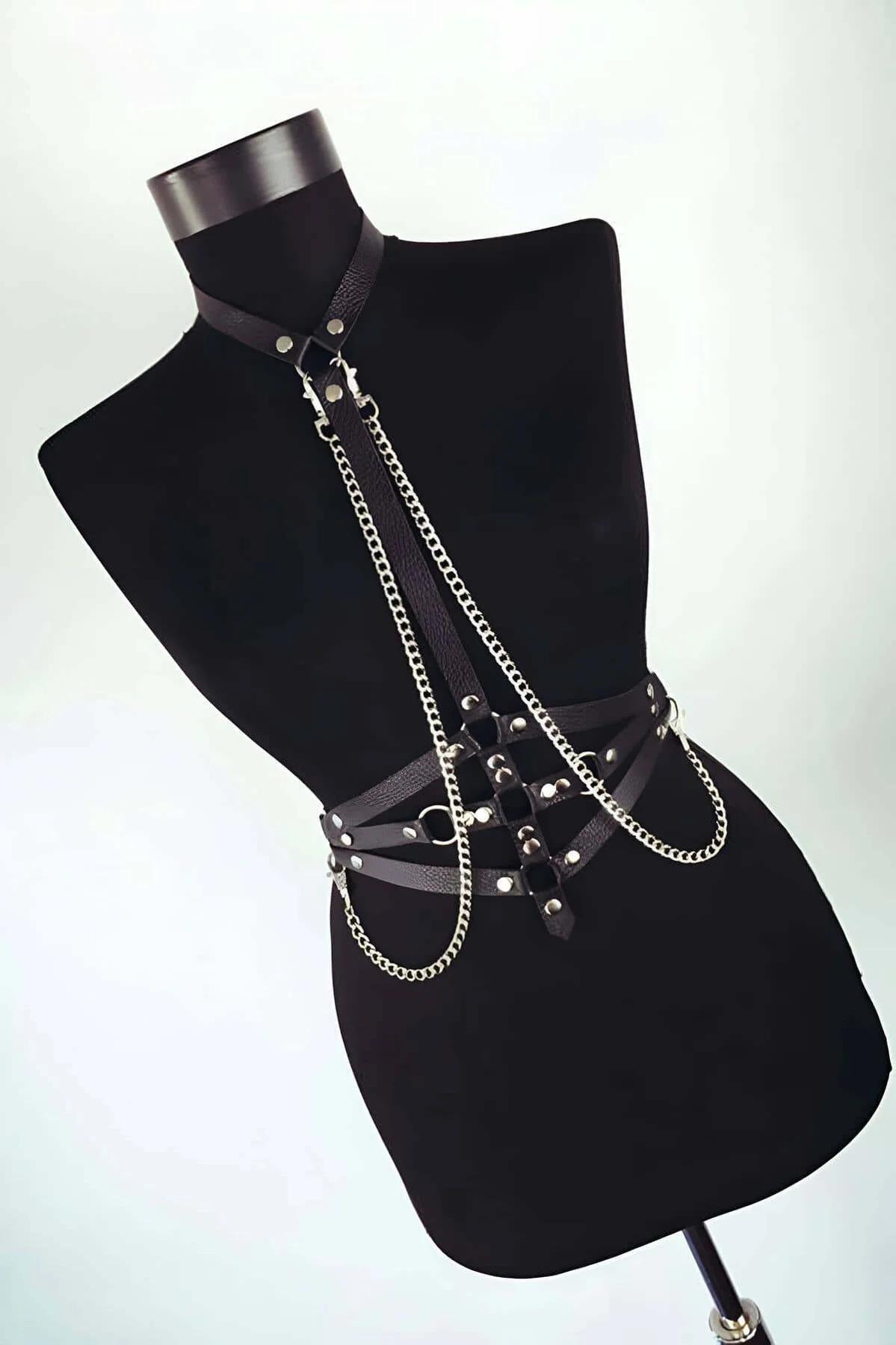 rear view of black faux leather body harness showing adjustable buckle closures and waist belt