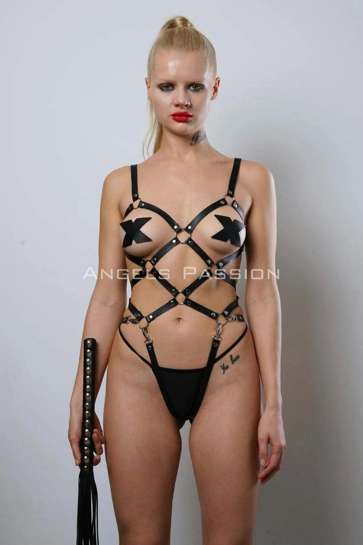 Detail of silver D-rings at hip level on black PU leather adjustable body harness