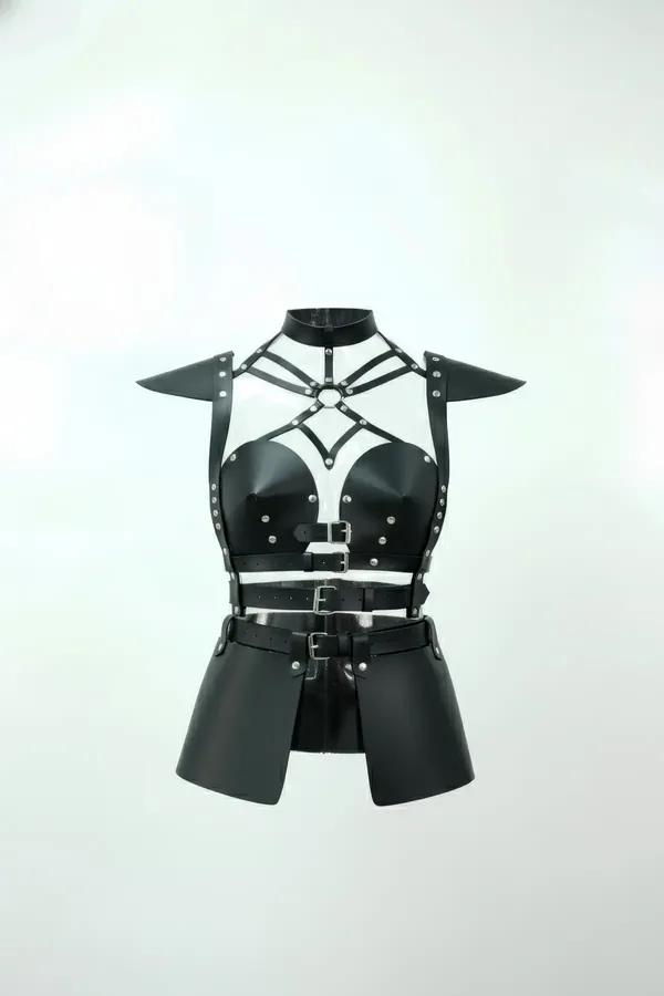 Black faux leather body harness with studded cups, rigid angular shoulder armor panels, and triple-buckle waist skirt
