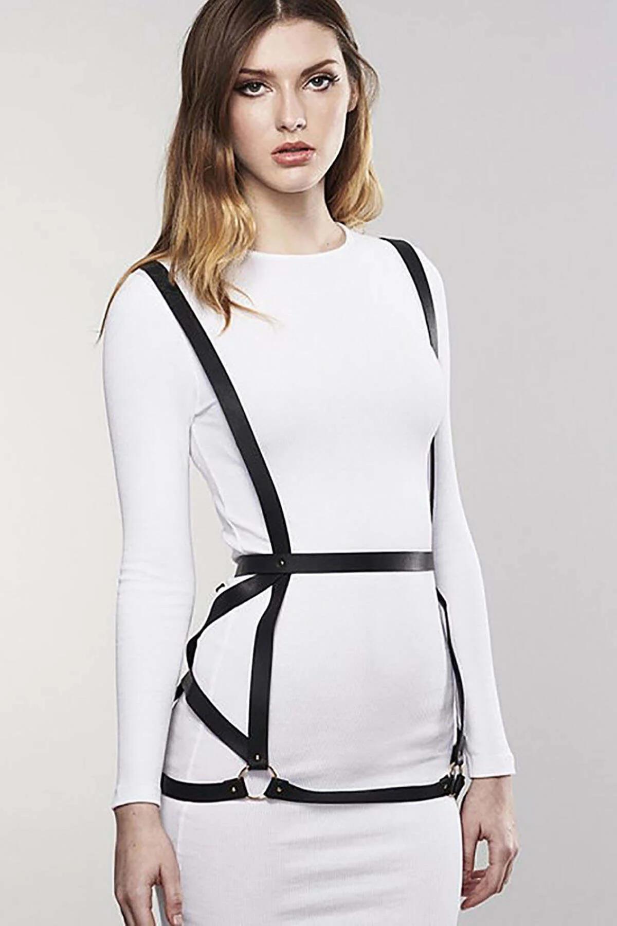 black body harness layered over black sleeveless bodysuit with waist cage frame visible