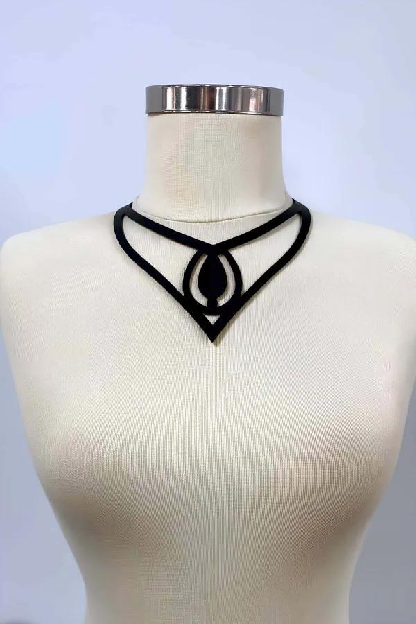 Black matte faux leather choker necklace with geometric V-drop and teardrop cutout medallion on mannequin