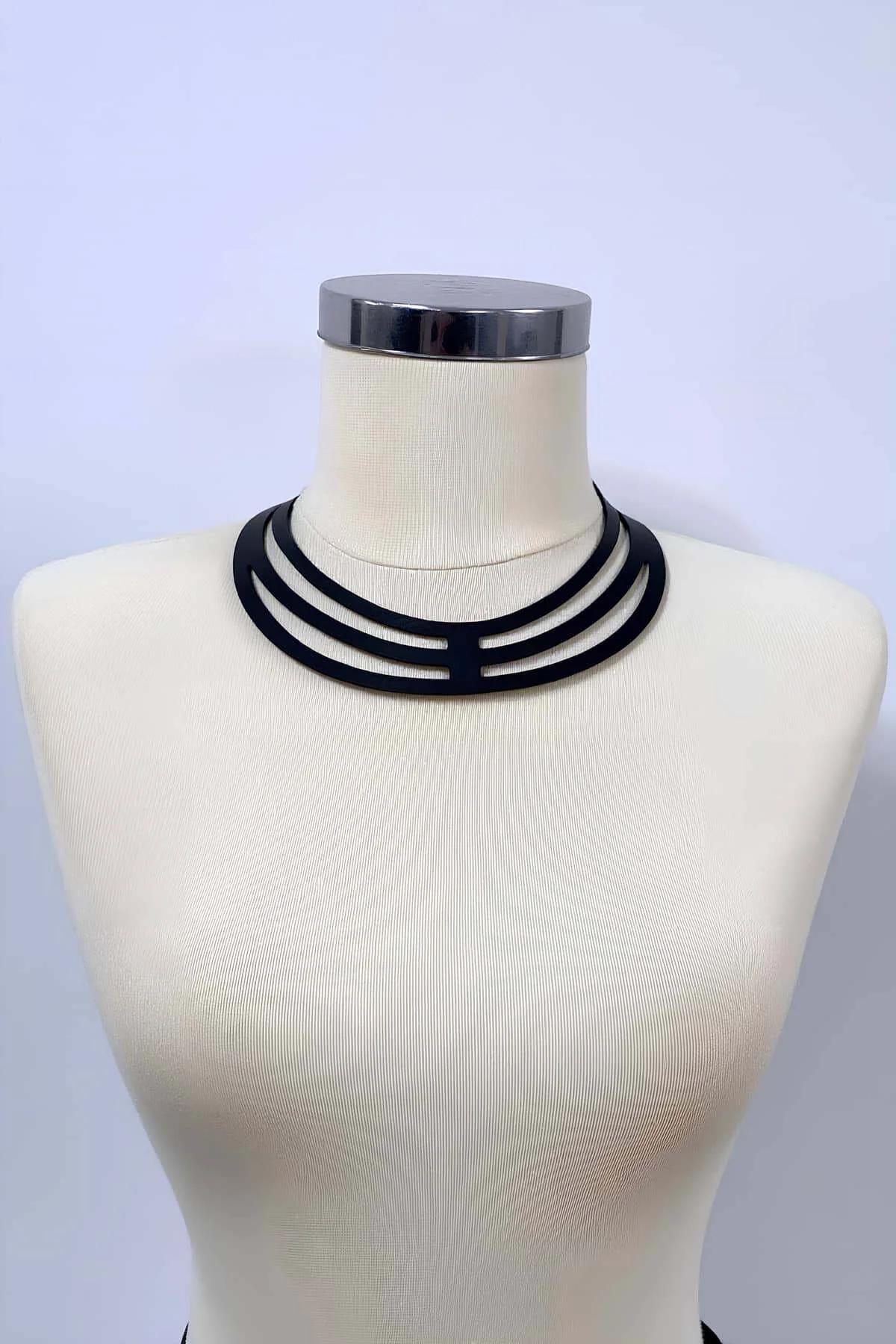 close-up of black matte PU strap choker harness showing three-band ladder cut-out detail