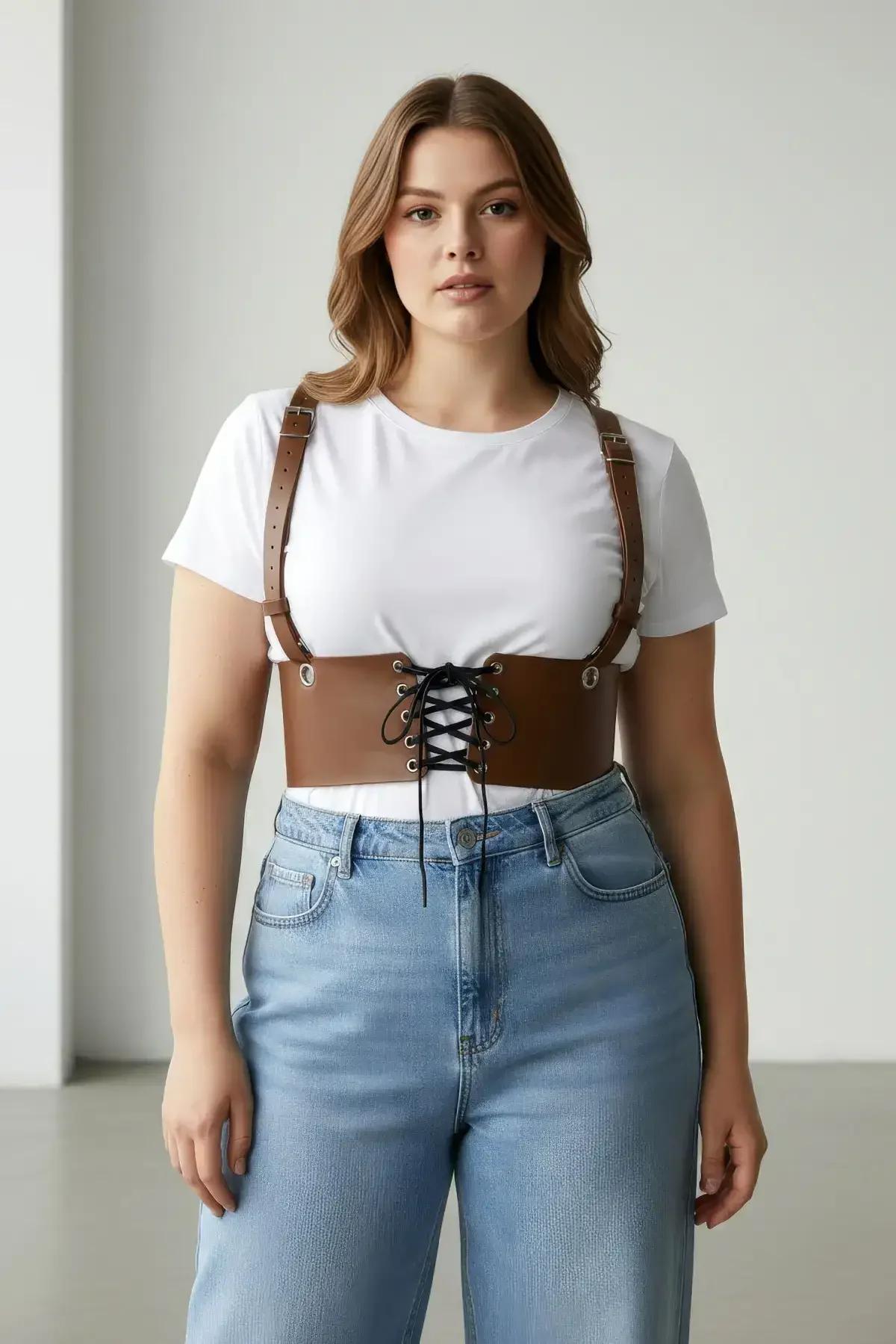 Close-up of black lace-up cord threaded through six metal eyelets on cognac corset harness belt