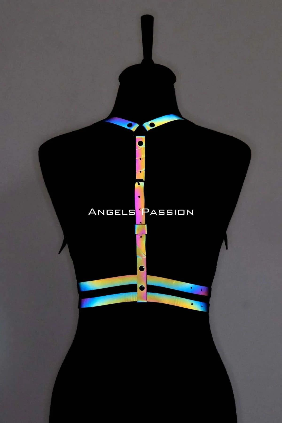 Close-up of reflective rainbow strap material with micro-prism color shift in blue green yellow tones