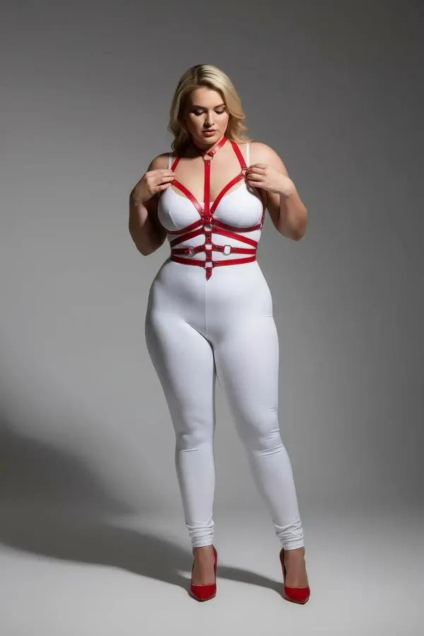 red faux leather full body harness with detachable silver O-ring chain and multi-strap cage silhouette worn on model