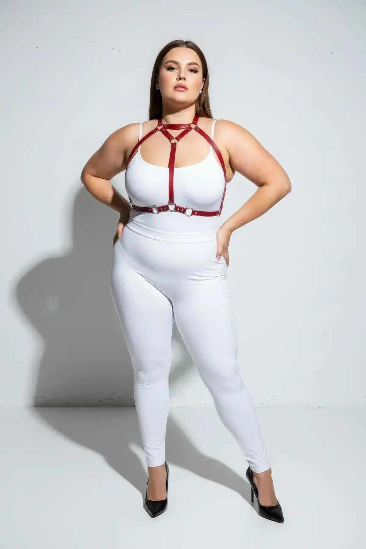 Red strappy chest harness with choker neck strap worn over white bodysuit, full front view