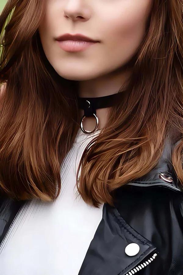 Black faux leather O-ring choker necklace with silver hardware worn at the neck, 2.5 cm wide band