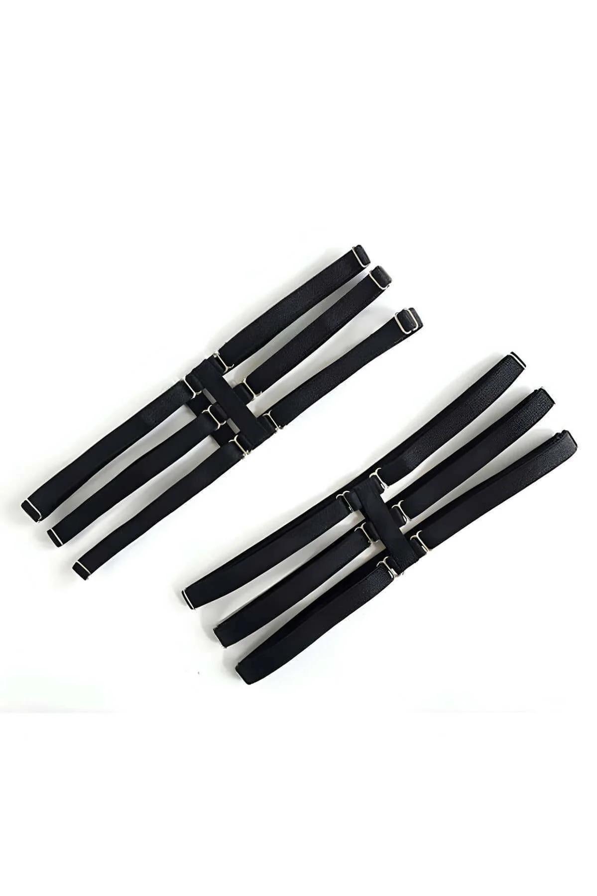 Close-up of three parallel black PU bands with polished silver buckles on the thigh