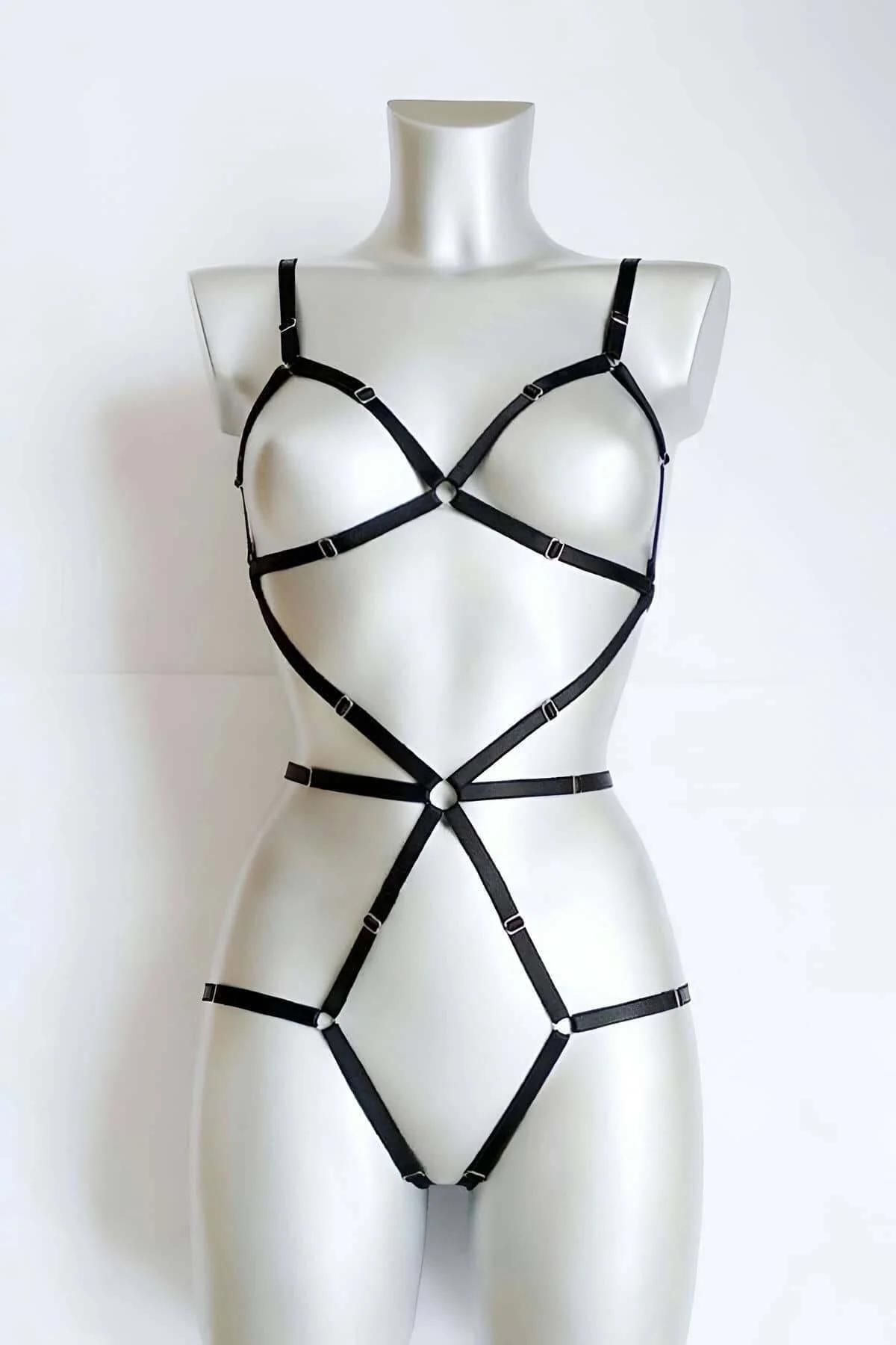 Black faux leather full body harness with two silver O-ring accents at chest and waist on mannequin
