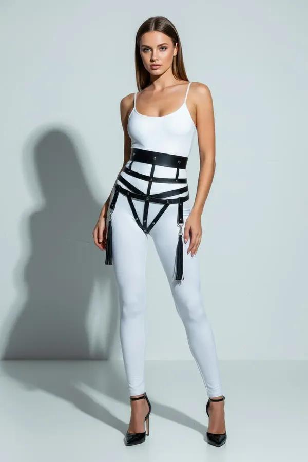 black faux leather caged waist harness with silver O-rings and tassel drops worn over white bodysuit